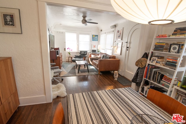 interior space featuring ceiling fan and dark hardwood / wood-style flooring