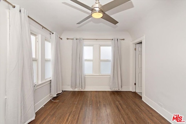 spare room featuring dark wood-type flooring and ceiling fan