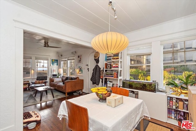 dining room with dark hardwood / wood-style flooring, crown molding, and ceiling fan