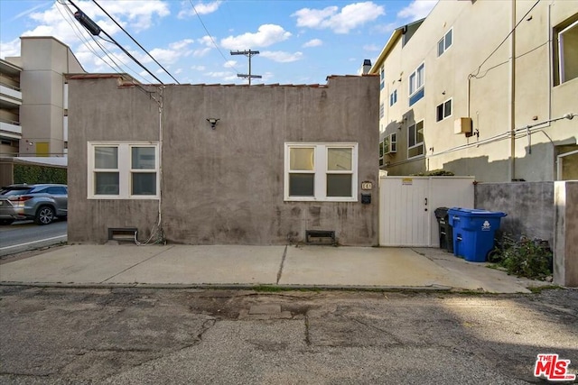 view of property exterior with a patio area