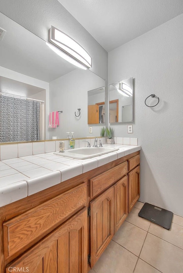 bathroom featuring tile patterned flooring and vanity