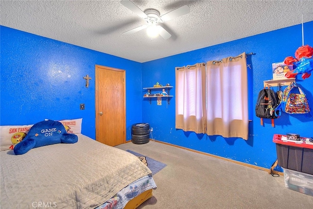 bedroom featuring ceiling fan, carpet flooring, and a textured ceiling