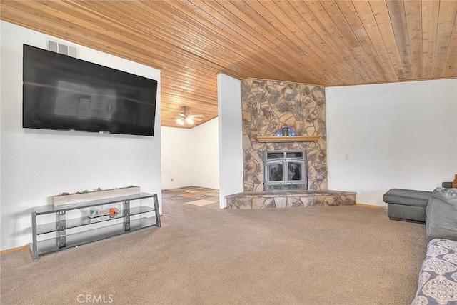 carpeted living room featuring wooden ceiling and a stone fireplace