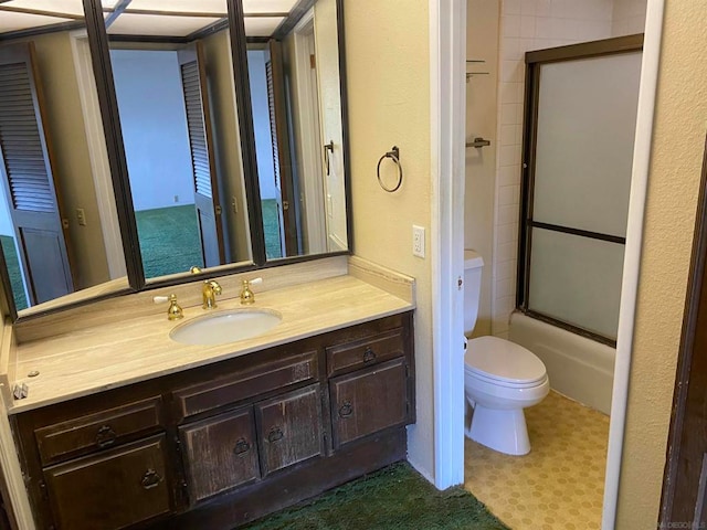 full bathroom featuring toilet, enclosed tub / shower combo, and vanity