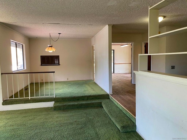 hall with a textured ceiling and hardwood / wood-style floors