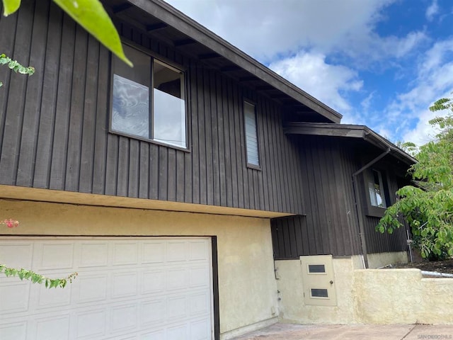 view of side of property featuring a garage