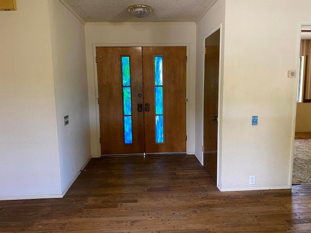 entryway featuring a textured ceiling, dark hardwood / wood-style flooring, and ornamental molding