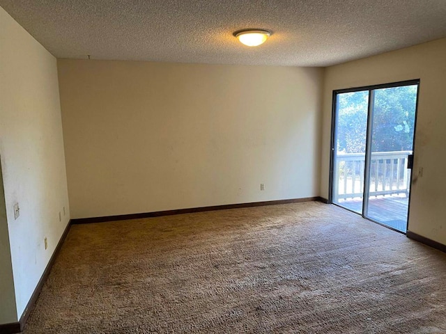 unfurnished room featuring carpet and a textured ceiling