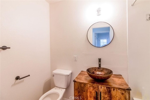 bathroom with toilet and vanity