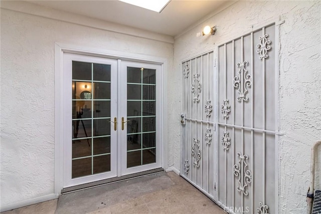 view of exterior entry featuring french doors