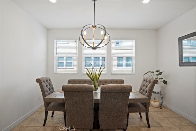 tiled dining space featuring an inviting chandelier and plenty of natural light