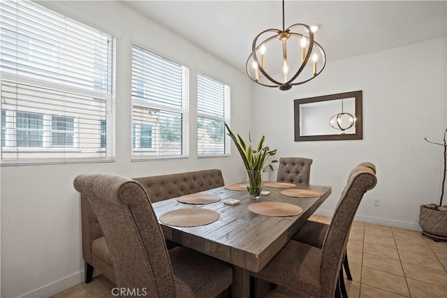 dining area with light tile patterned floors and a notable chandelier