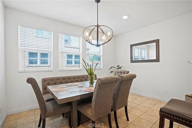 tiled dining room with a notable chandelier