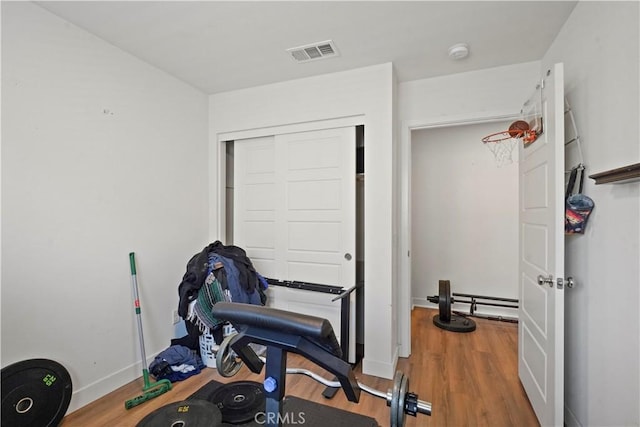 workout area with hardwood / wood-style floors