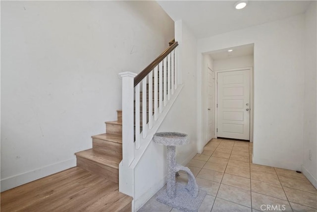 stairs with hardwood / wood-style flooring