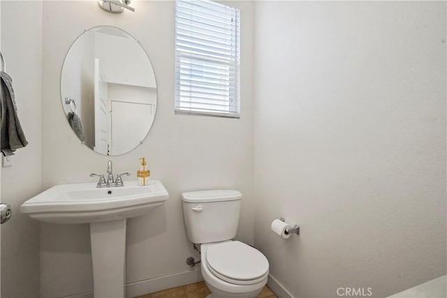 bathroom with tile patterned flooring and toilet