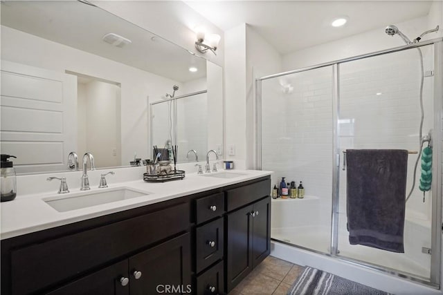 bathroom featuring tile patterned flooring, vanity, and a shower with shower door