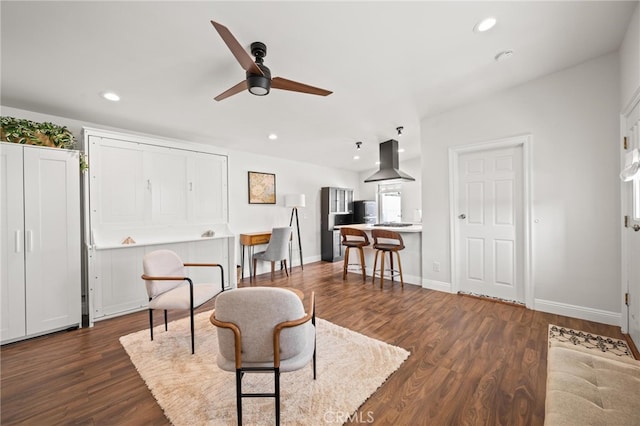 living room featuring ceiling fan and dark hardwood / wood-style floors