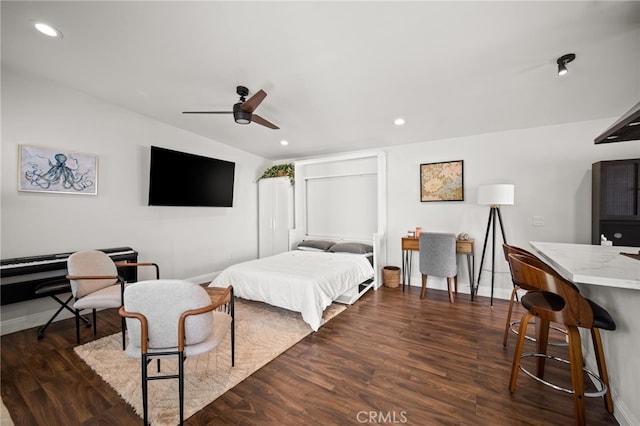 bedroom with ceiling fan and dark hardwood / wood-style flooring