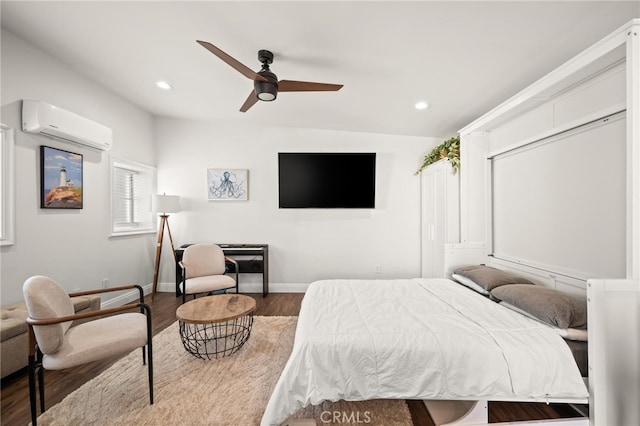 bedroom featuring ceiling fan, a closet, hardwood / wood-style floors, and a wall mounted air conditioner