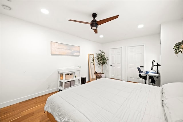 bedroom with hardwood / wood-style floors and ceiling fan