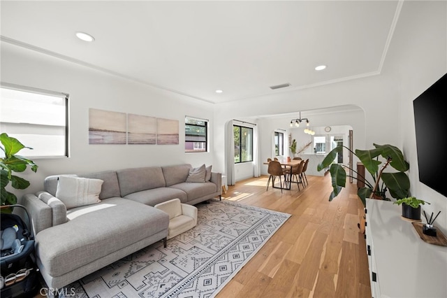 living room with a chandelier and light hardwood / wood-style floors