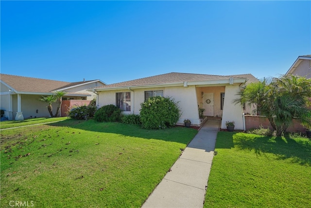 ranch-style house featuring a garage and a front lawn