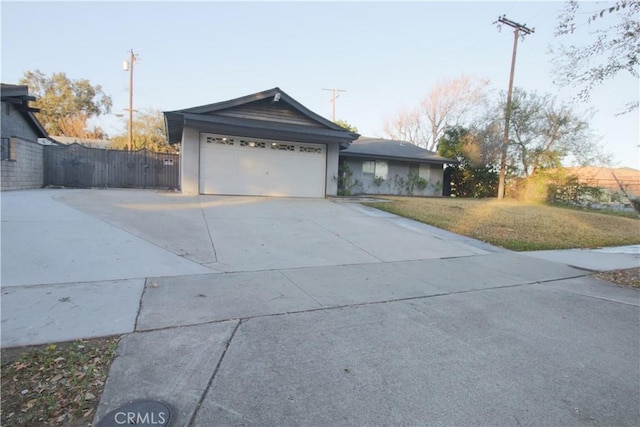 view of property exterior featuring a garage and a lawn