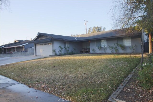 ranch-style house with a front lawn and a garage