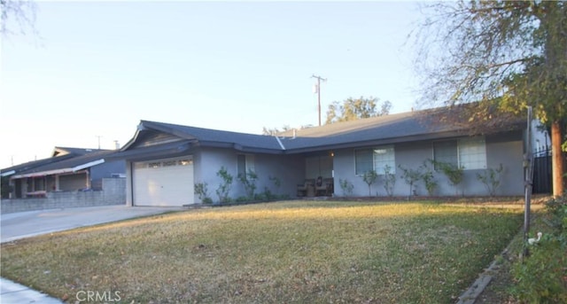 ranch-style house with a garage and a front lawn