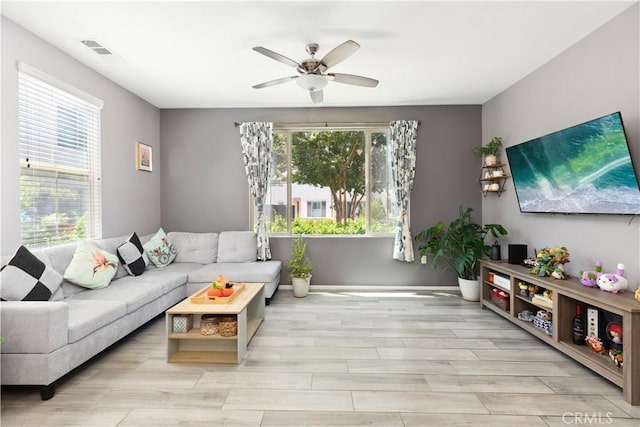 living room featuring ceiling fan and light hardwood / wood-style flooring