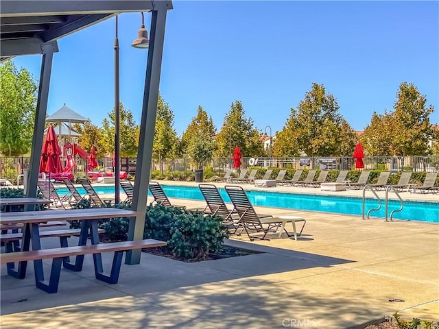 view of pool featuring a playground and a patio area