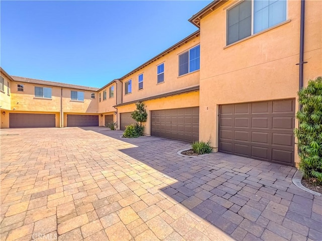 townhome / multi-family property featuring a garage