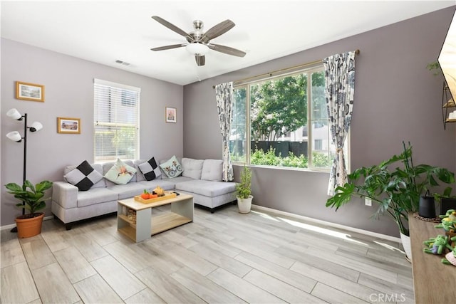 living room with ceiling fan and light hardwood / wood-style flooring