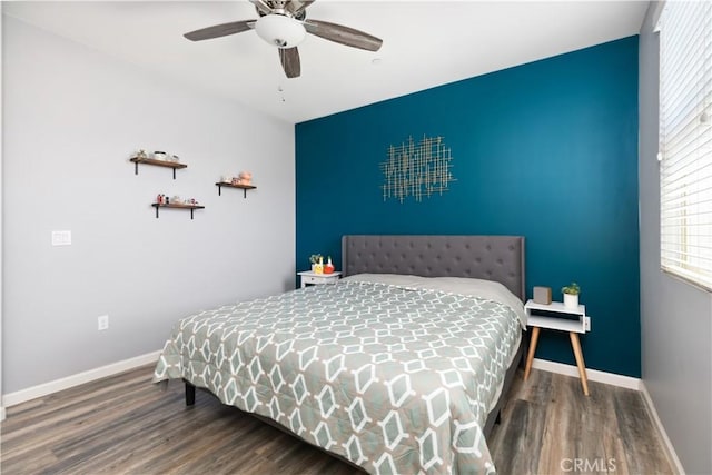 bedroom with ceiling fan and dark hardwood / wood-style floors