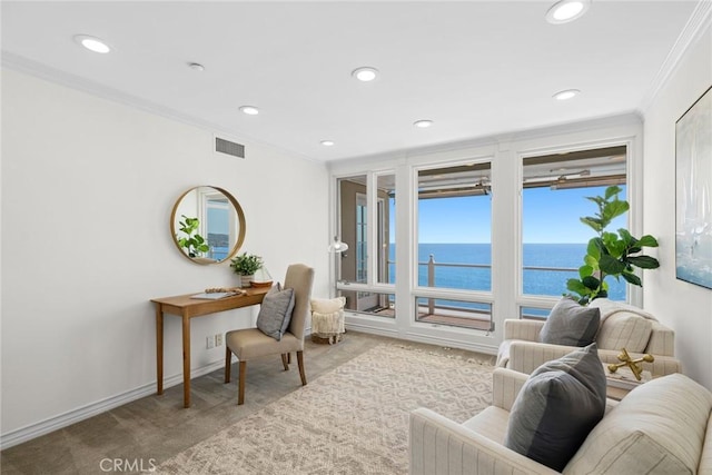 living room with carpet flooring, a water view, and ornamental molding