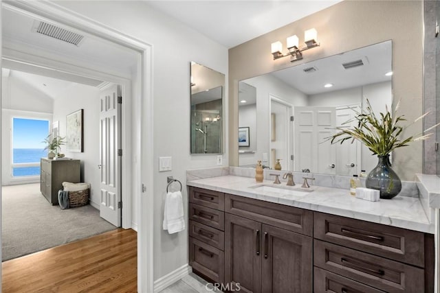 bathroom with wood-type flooring, vanity, and a water view