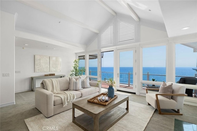 carpeted living room featuring beamed ceiling, a water view, and plenty of natural light