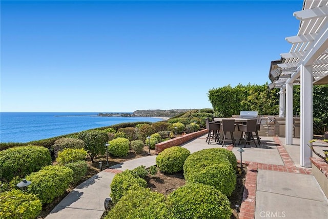 view of patio featuring a pergola, a water view, and area for grilling