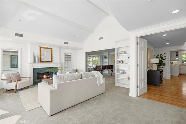 living room featuring a fireplace, light hardwood / wood-style floors, lofted ceiling, and pool table