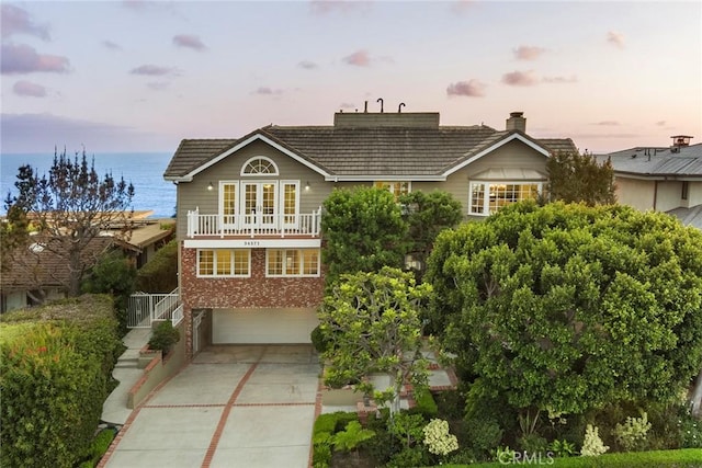 front facade featuring a garage and a water view