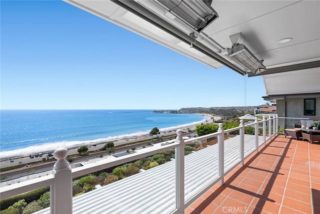 balcony with a water view and a beach view