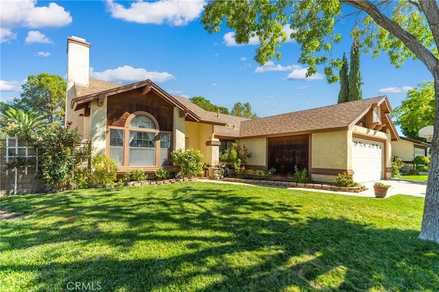 view of front of house with a front yard and a garage