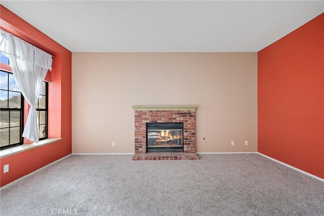 unfurnished living room with a fireplace and carpet