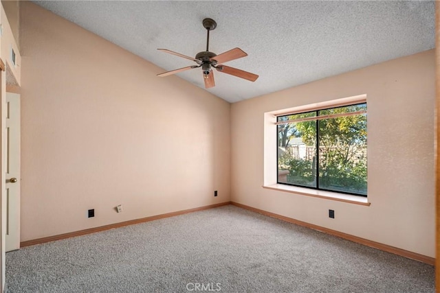 carpeted spare room with vaulted ceiling, ceiling fan, and a textured ceiling