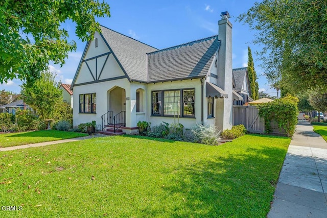 english style home with a front lawn