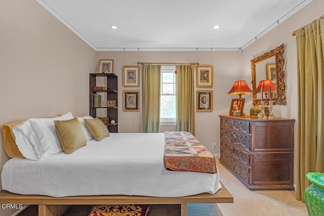 bedroom with crown molding and light carpet