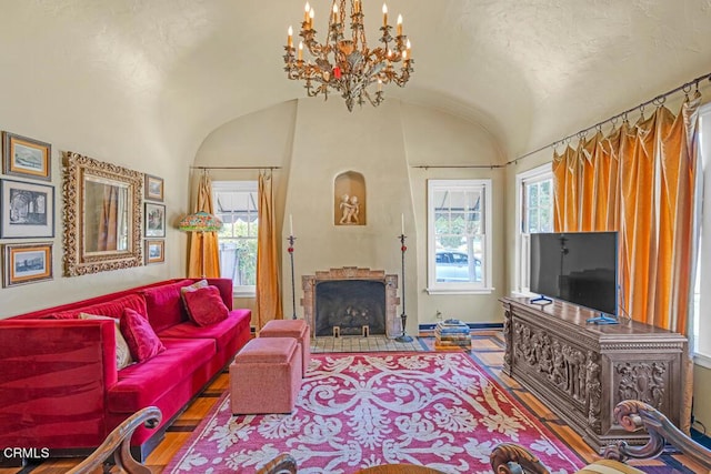 living room with hardwood / wood-style floors, an inviting chandelier, and lofted ceiling