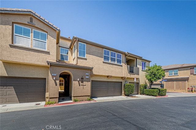 multi unit property featuring a garage