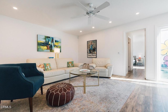 living room with hardwood / wood-style flooring and ceiling fan